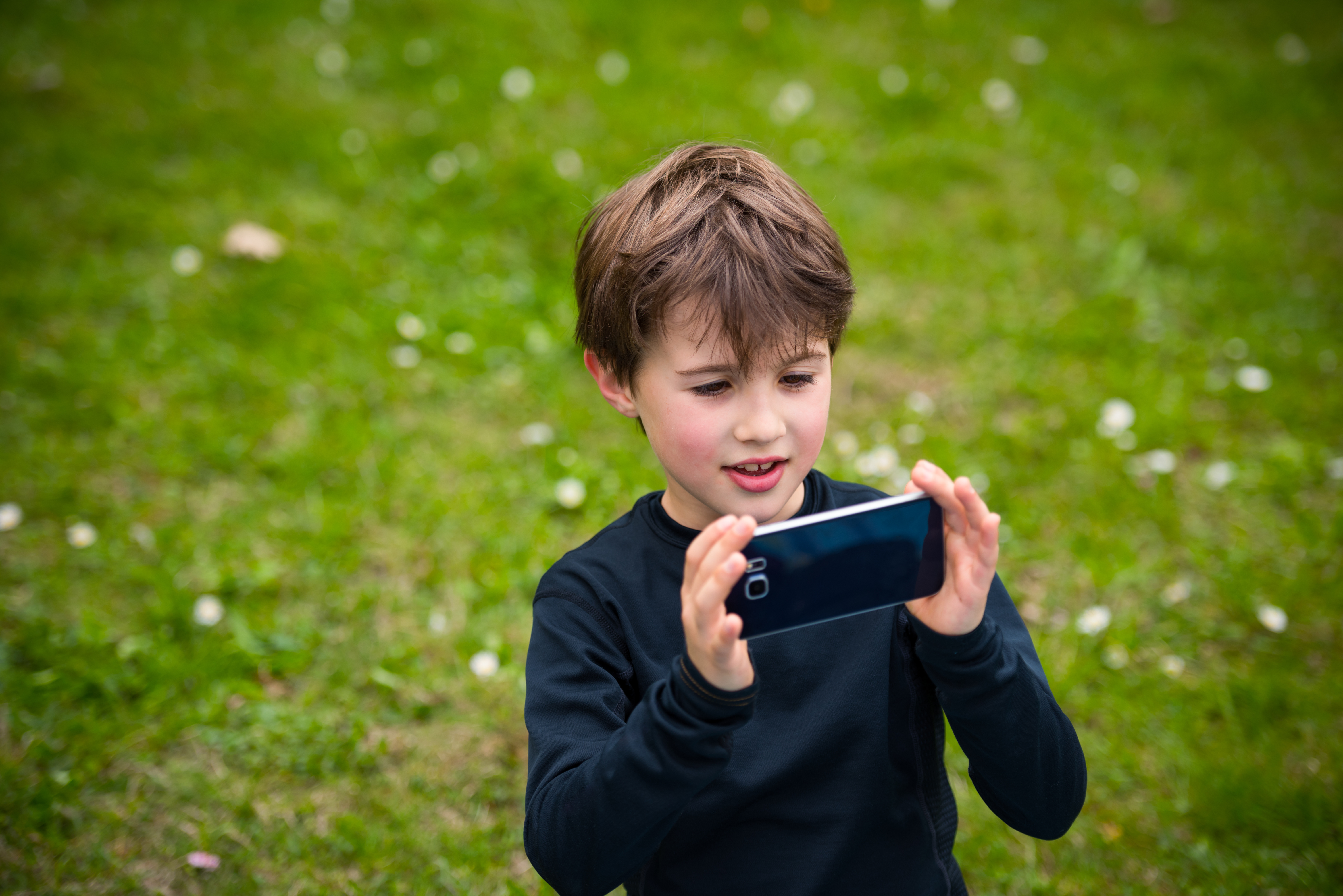 young boy using smartphone